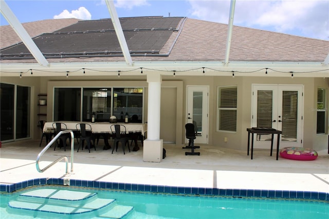 8039 Agate St, Port Charlotte, FL 33981 - back of house featuring french doors, a shingled roof, a patio area, and an outdoor pool