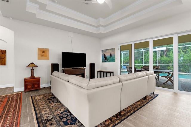 2453 Harbour Dr, Punta Gorda, FL 33983 - living area with crown molding, a ceiling fan, wood tiled floors, and a tray ceiling