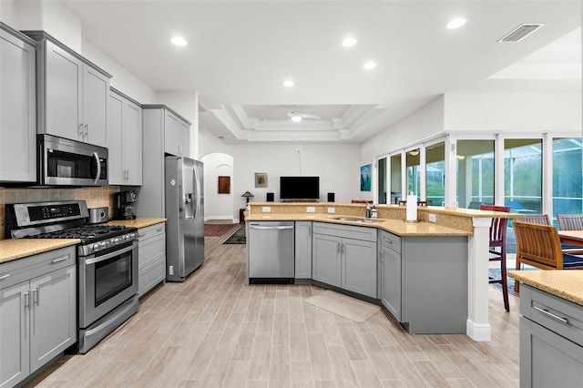 2453 Harbour Dr, Punta Gorda, FL 33983 - kitchen featuring stainless steel appliances, gray cabinets, arched walkways, ornamental molding, and a ceiling fan