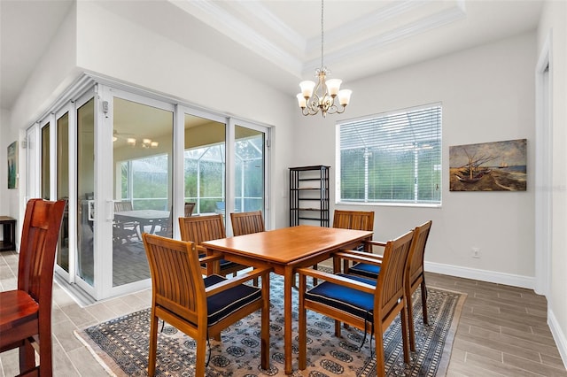 2453 Harbour Dr, Punta Gorda, FL 33983 - dining room featuring crown molding, wood finish floors, a chandelier, and a raised ceiling