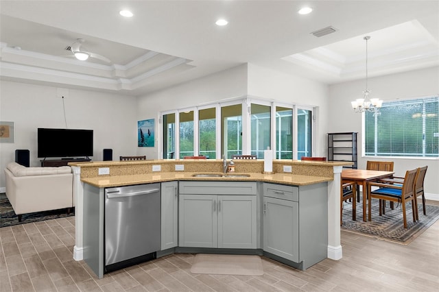 2453 Harbour Dr, Punta Gorda, FL 33983 - kitchen featuring stainless steel dishwasher, a tray ceiling, crown molding, open floor plan, and wood finish floors