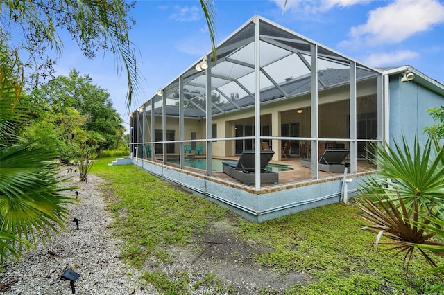 2453 Harbour Dr, Punta Gorda, FL 33983 - back of house with an outdoor pool, stucco siding, a patio area, and a lanai
