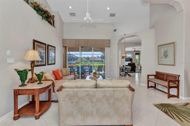 771 Rotonda Cir, Rotonda West, FL 33947 - living area with ceiling fan, arched walkways, a high ceiling, and light tile patterned flooring