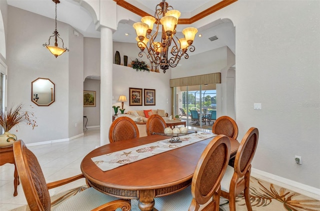 771 Rotonda Cir, Rotonda West, FL 33947 - dining room with a chandelier, decorative columns, light tile patterned flooring, arched walkways, and a high ceiling