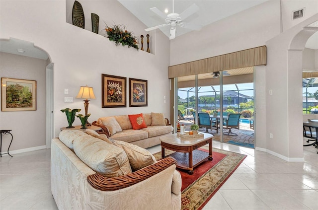 771 Rotonda Cir, Rotonda West, FL 33947 - living room with a sunroom, arched walkways, a ceiling fan, high vaulted ceiling, and light tile patterned floors