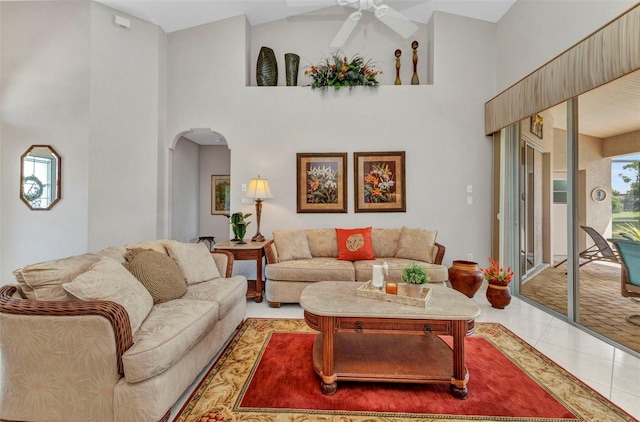 771 Rotonda Cir, Rotonda West, FL 33947 - living area with arched walkways, a ceiling fan, a towering ceiling, and tile patterned flooring