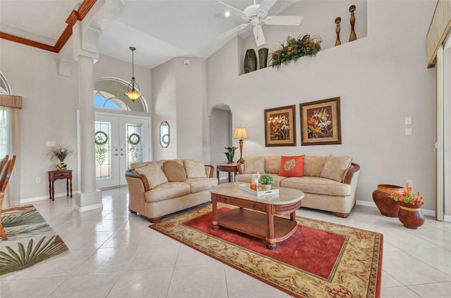 771 Rotonda Cir, Rotonda West, FL 33947 - living room featuring light tile patterned flooring, a high ceiling, arched walkways, ceiling fan, and french doors