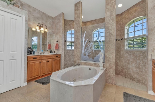 771 Rotonda Cir, Rotonda West, FL 33947 - bathroom with a jetted tub, vanity, a walk in shower, tile walls, and tile patterned floors