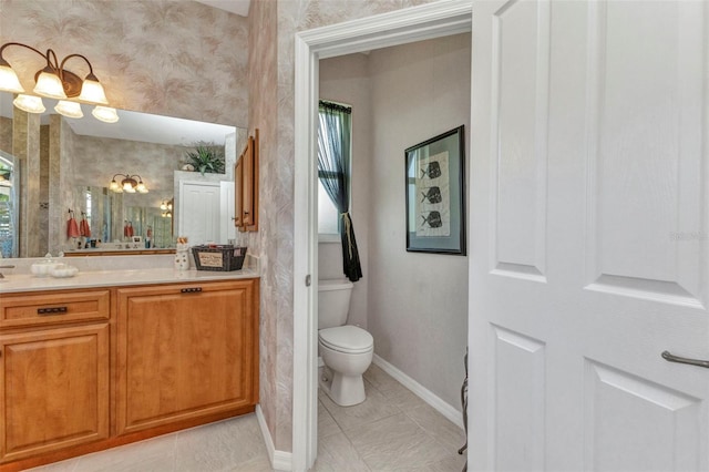 771 Rotonda Cir, Rotonda West, FL 33947 - bathroom featuring vanity, plenty of natural light, and wallpapered walls