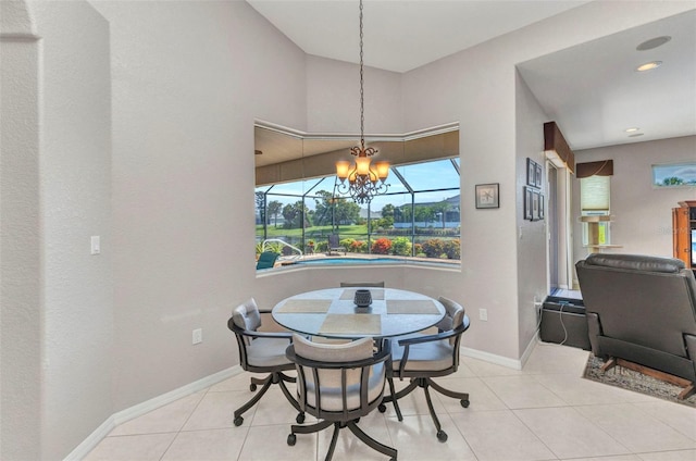 771 Rotonda Cir, Rotonda West, FL 33947 - tiled dining space featuring a chandelier and baseboards