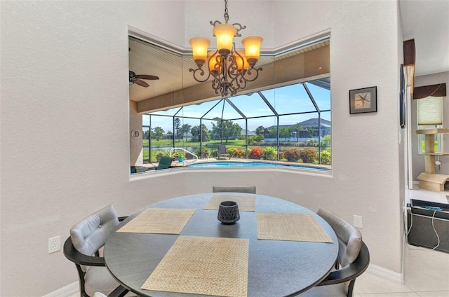 771 Rotonda Cir, Rotonda West, FL 33947 - tiled dining space with a sunroom, a textured wall, a chandelier, and a ceiling fan