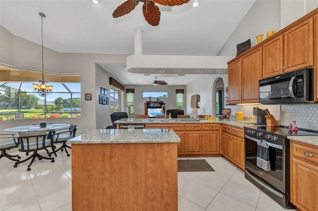 771 Rotonda Cir, Rotonda West, FL 33947 - kitchen featuring electric stove, black microwave, ceiling fan, a peninsula, and light stone countertops