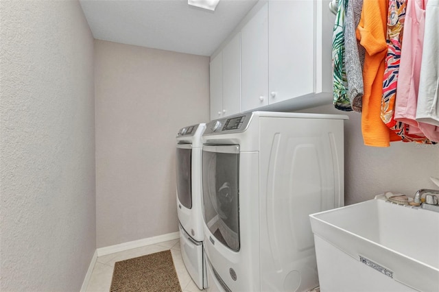 771 Rotonda Cir, Rotonda West, FL 33947 - washroom featuring washer and clothes dryer, light tile patterned floors, and cabinet space