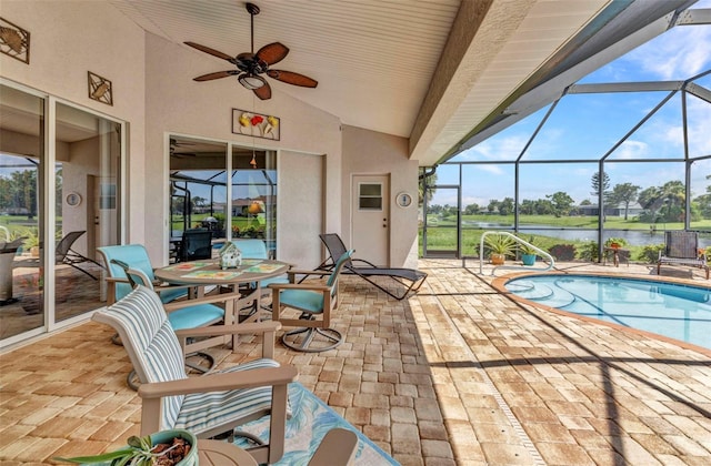 771 Rotonda Cir, Rotonda West, FL 33947 - view of patio featuring a water view, a ceiling fan, an outdoor pool, and glass enclosure