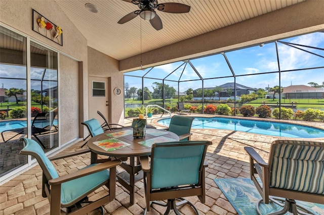771 Rotonda Cir, Rotonda West, FL 33947 - view of patio / terrace with an outdoor pool, glass enclosure, ceiling fan, and outdoor dining area