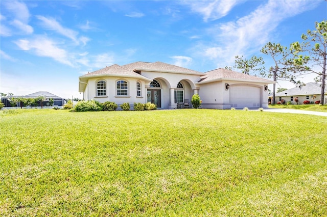 771 Rotonda Cir, Rotonda West, FL 33947 - mediterranean / spanish house featuring an attached garage, a front lawn, stucco siding, and driveway