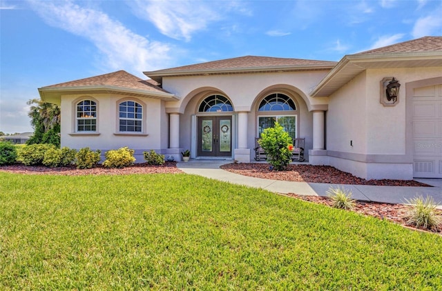 771 Rotonda Cir, Rotonda West, FL 33947 - property entrance featuring french doors, a yard, and stucco siding
