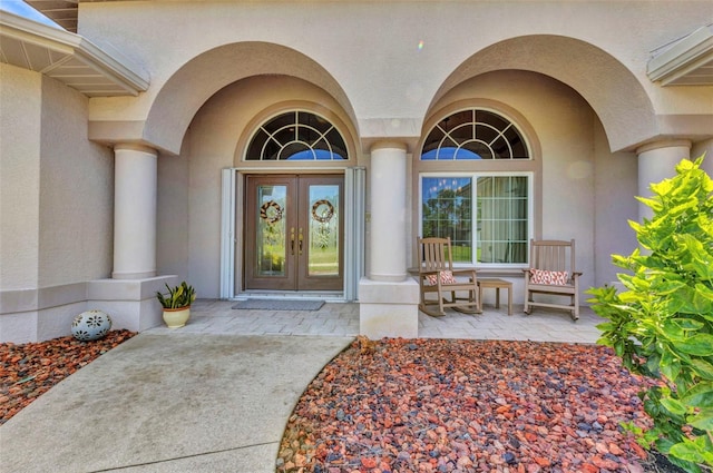 771 Rotonda Cir, Rotonda West, FL 33947 - view of exterior entry featuring french doors, stucco siding, and a porch