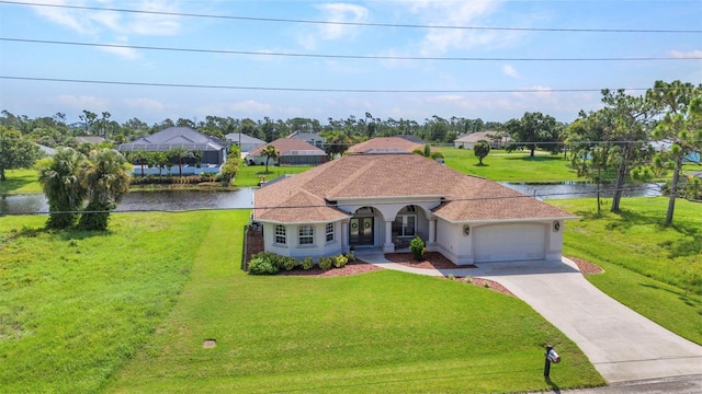 771 Rotonda Cir, Rotonda West, FL 33947 - mediterranean / spanish-style house featuring a garage, driveway, a front yard, and a water view