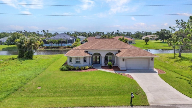 771 Rotonda Cir, Rotonda West, FL 33947 - mediterranean / spanish-style home with an attached garage, a water view, a front yard, french doors, and driveway