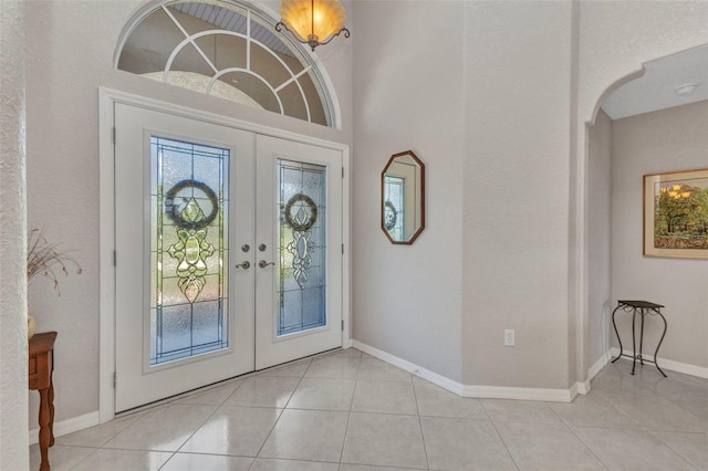 771 Rotonda Cir, Rotonda West, FL 33947 - foyer entrance with french doors, light tile patterned floors, and arched walkways