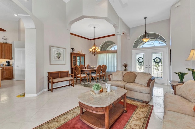 771 Rotonda Cir, Rotonda West, FL 33947 - living area with a towering ceiling, a chandelier, healthy amount of natural light, light tile patterned flooring, and french doors