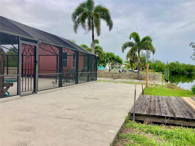 232 Darst Ave, Punta Gorda, FL 33950 - view of patio with glass enclosure, an outdoor pool, and a water view