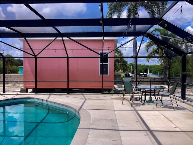 232 Darst Ave, Punta Gorda, FL 33950 - outdoor pool with a patio area, glass enclosure, and outdoor dining space