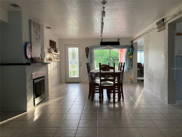 232 Darst Ave, Punta Gorda, FL 33950 - dining room featuring a fireplace, a textured ceiling, and tile patterned floors