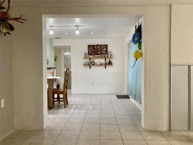 232 Darst Ave, Punta Gorda, FL 33950 - hall with a textured wall and light tile patterned flooring