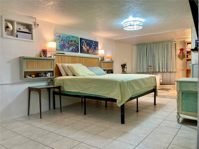 232 Darst Ave, Punta Gorda, FL 33950 - bedroom with a textured ceiling and light tile patterned flooring