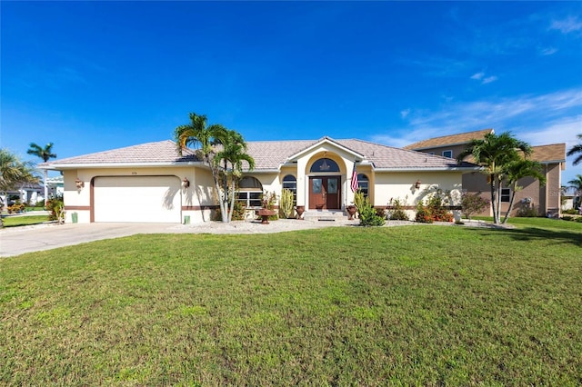 574 Macedonia Dr, Punta Gorda, FL 33950 - ranch-style house featuring a garage, concrete driveway, a front yard, french doors, and stucco siding