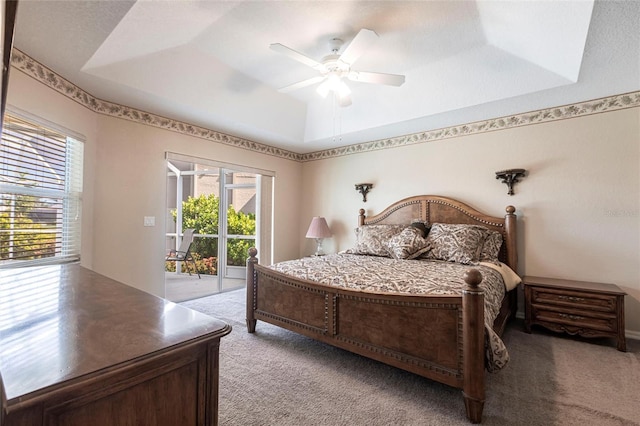 574 Macedonia Dr, Punta Gorda, FL 33950 - bedroom featuring light carpet, access to exterior, a raised ceiling, and a ceiling fan