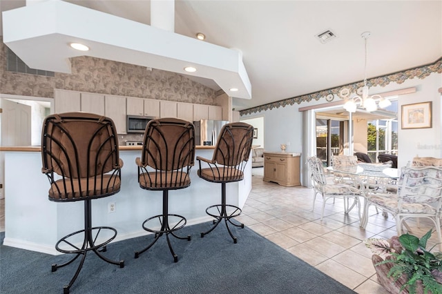 574 Macedonia Dr, Punta Gorda, FL 33950 - kitchen featuring a kitchen bar, stainless steel appliances, a chandelier, decorative light fixtures, and recessed lighting