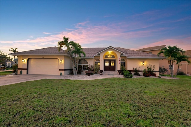 574 Macedonia Dr, Punta Gorda, FL 33950 - view of front facade featuring an attached garage, concrete driveway, stucco siding, and a front yard