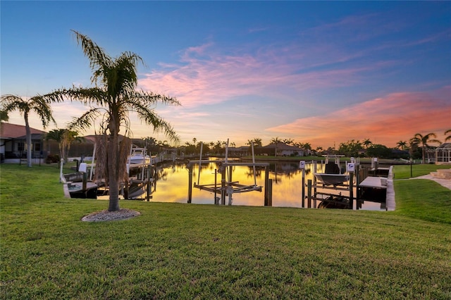 574 Macedonia Dr, Punta Gorda, FL 33950 - dock area featuring boat lift, a water view, and a yard