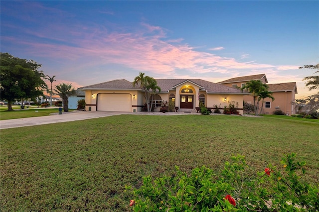 574 Macedonia Dr, Punta Gorda, FL 33950 - mediterranean / spanish-style house with concrete driveway, a garage, a yard, and stucco siding