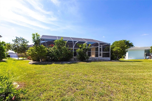 574 Macedonia Dr, Punta Gorda, FL 33950 - rear view of property featuring a lawn and glass enclosure