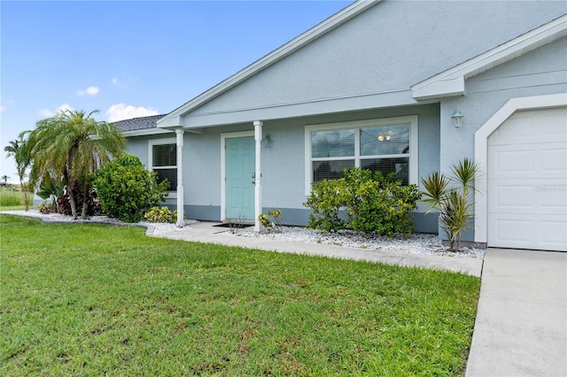 17103 Horizon Ln, Port Charlotte, FL 33948 - doorway to property featuring stucco siding, a lawn, and an attached garage