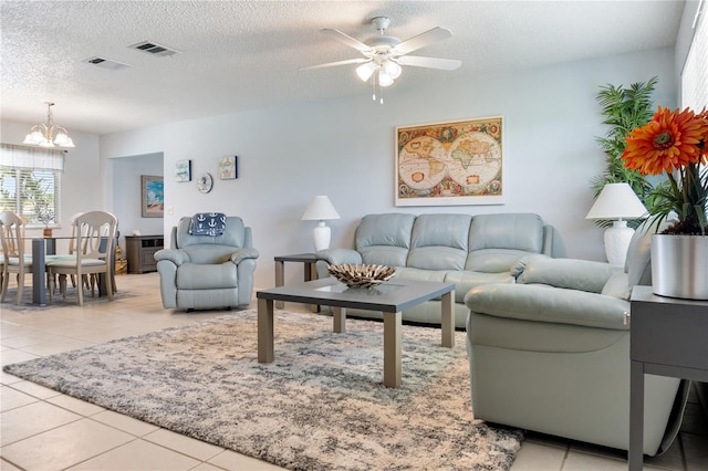 17103 Horizon Ln, Port Charlotte, FL 33948 - living area with a chandelier, tile patterned floors, a ceiling fan, and a textured ceiling
