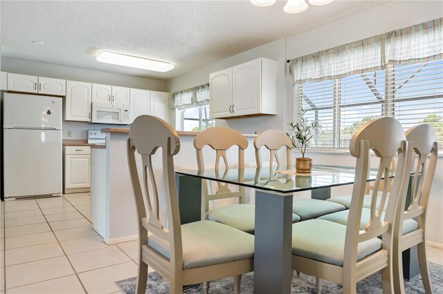 17103 Horizon Ln, Port Charlotte, FL 33948 - dining room featuring light tile patterned floors and a textured ceiling