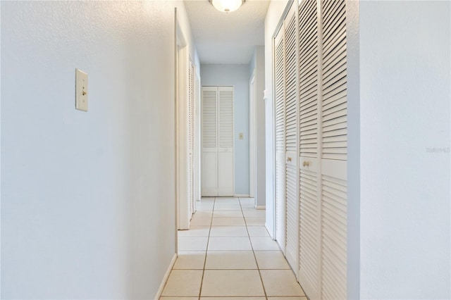 17103 Horizon Ln, Port Charlotte, FL 33948 - hallway featuring light tile patterned flooring and baseboards