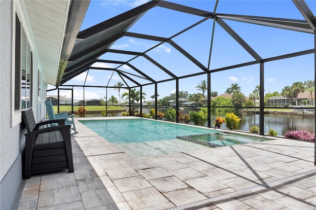 17103 Horizon Ln, Port Charlotte, FL 33948 - view of swimming pool with a water view, a patio area, a pool with connected hot tub, and glass enclosure