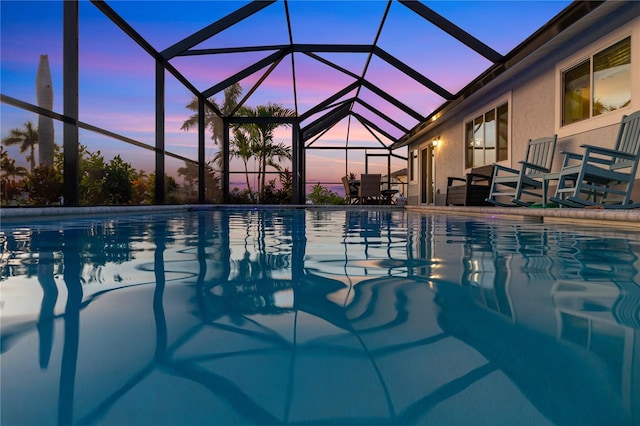 17103 Horizon Ln, Port Charlotte, FL 33948 - pool at dusk featuring an outdoor pool, a lanai, and a patio