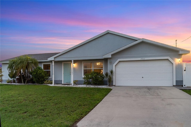 17103 Horizon Ln, Port Charlotte, FL 33948 - single story home with a garage, a lawn, driveway, and stucco siding