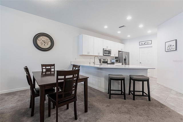 8516 Cache Dr, Sarasota, FL 34240 - dining space with recessed lighting, light carpet, and light tile patterned flooring