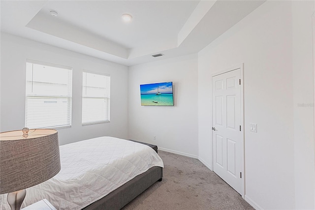 8516 Cache Dr, Sarasota, FL 34240 - carpeted bedroom with a tray ceiling and baseboards