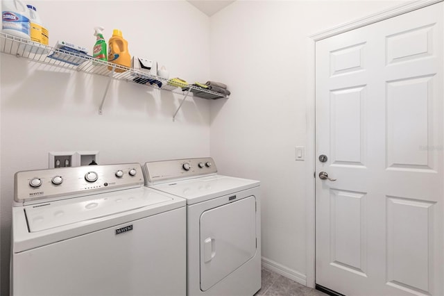 8516 Cache Dr, Sarasota, FL 34240 - laundry area featuring washer and clothes dryer and baseboards
