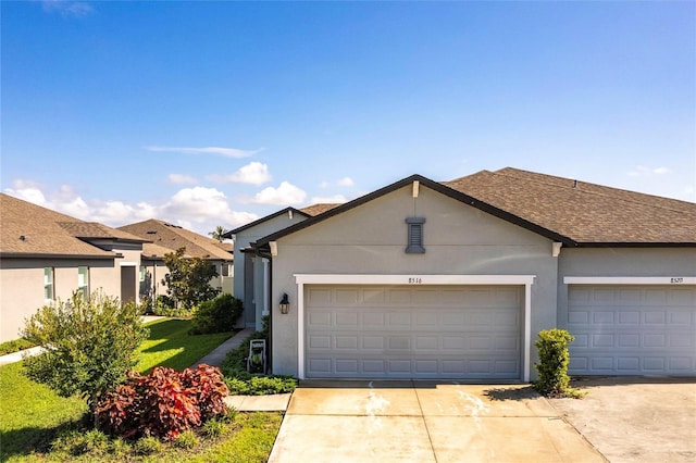 8516 Cache Dr, Sarasota, FL 34240 - ranch-style house featuring driveway, stucco siding, a shingled roof, and an attached garage