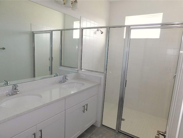8516 Cache Dr, Sarasota, FL 34240 - bathroom featuring a shower stall, double vanity, and tile patterned floors